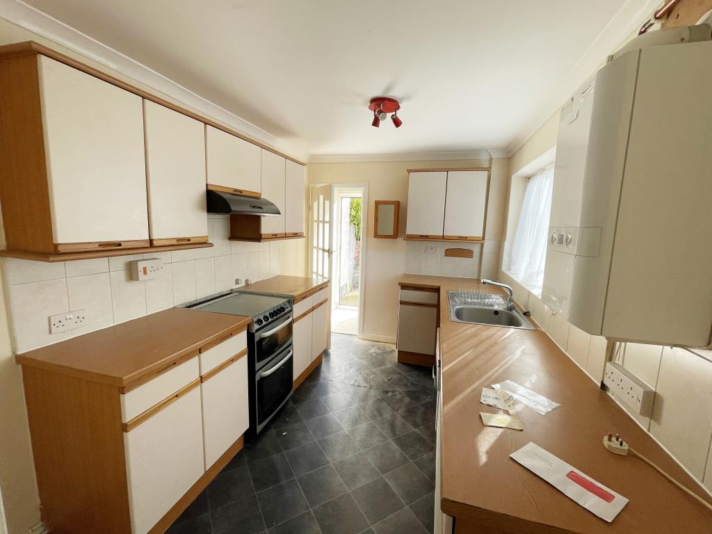 Lot: 1 - THREE-BEDROOM MID-TERRACE HOUSE - Kitchen with fitted units and boiler